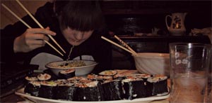 poorly lit photo of sushi