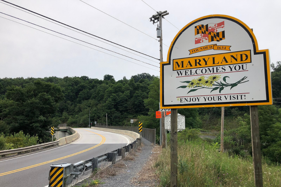 Side of a road which is curving to the left, with a sign on the right-hand side that says 'Maryland Welcomes You, Enjoy Your Visit!' Maryland becomes latest state to warn licensees about prediction markets
